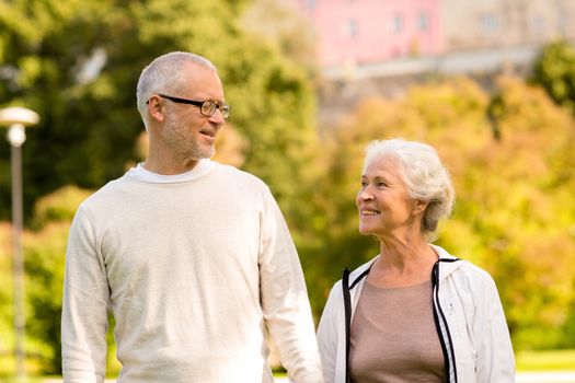 family, age, tourism, travel and people concept - senior couple in city park