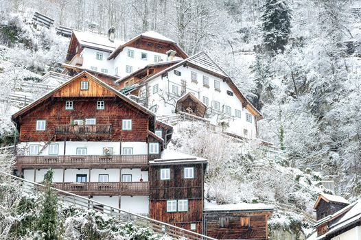 Traditional wooden houses on a hill slope in Alps mountains, Hallstatt, Austria