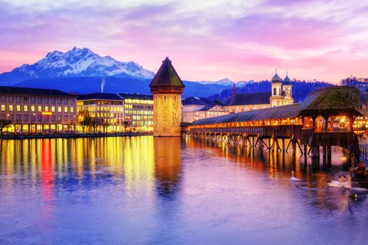Chapel bridge, Water tower and Mount Pilatus on sunset, Lucerne, Switzerland.