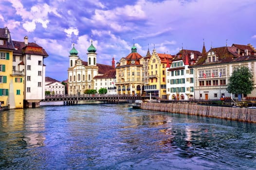 Lucerne, Switzerland, on sunset. View over Reuss river to Jesuit Church