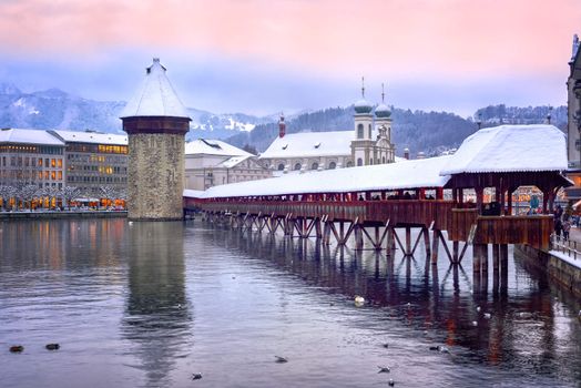 Lucerne, Switzerland, Chapel bridge, Water tower and Jesuit church on a winter evening