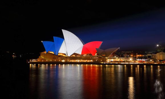 SYDNEY, AUSTRALIA - NOVEMBER 16, 2015;  Sydney Opera House lit up in colours of the French flag... blue, white and red in support of mulitple tragic terrorist events in France  by an islamic extremist group named ISIS