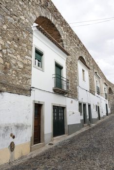 houses build in the old city wall in evora alentejo Portugal