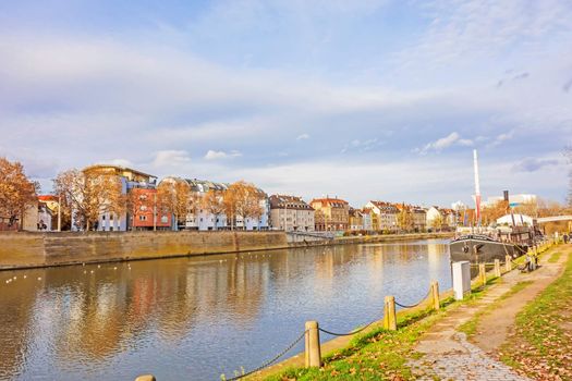 Stuttgart, Germany - November 14, 2015: River Neckar near the center of district Bad Cannstatt - road towards named Neckartalstrasse, showboat Theaterschiff Stuttgart / Frauenlob on the right.
