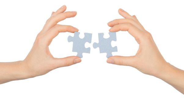 Hands holding puzzle pieces on isolated white background