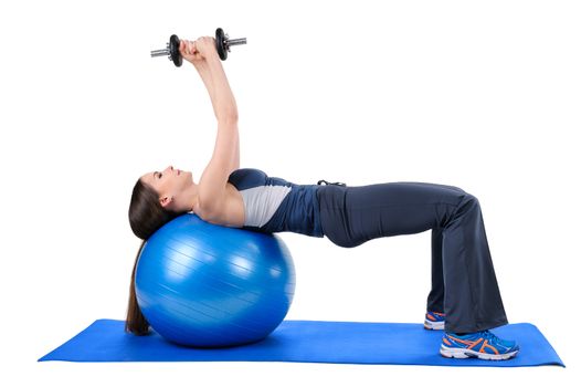 Young woman shows finishing position of Fitness Ball Dumbbell Pullover Workout, isolated on white