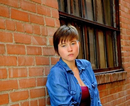 Female beauty expressions against a wall outside.