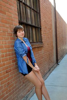 Female beauty expressions against a wall outside.