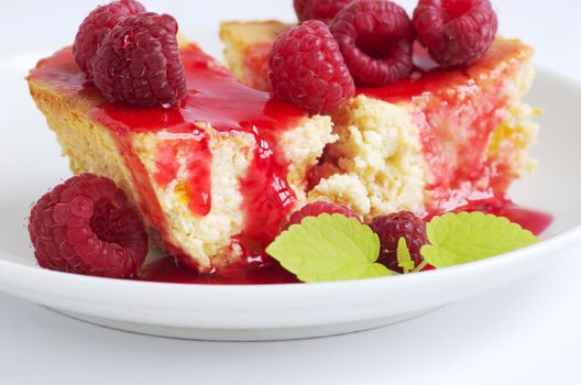 cake with raspberries and cream cheese decorated with fresh raspberries and mint. the toning. selective focus