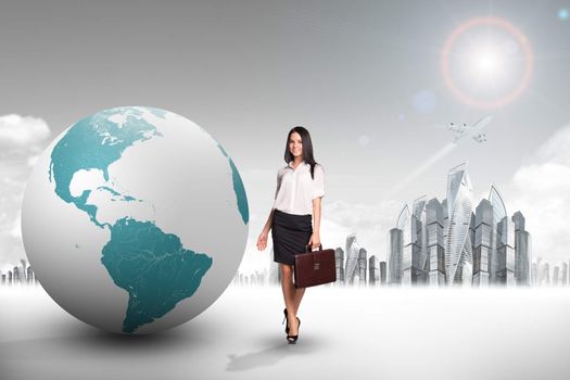 Buisnesswoman with big earth globe and city background