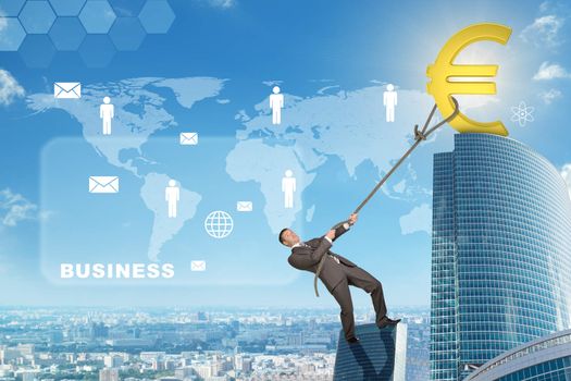 Businessman climbing skyscraper holding golden euro sign