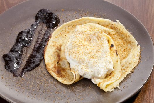 Crepe pancake with whipped cram and gingerbread powder