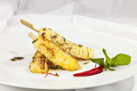 Grilled ananas with honey and mint leaves