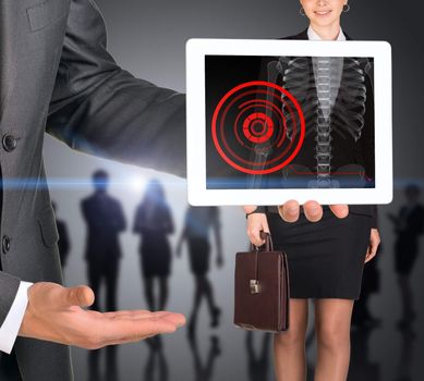 Businessman holding tablet with x-ray of woman