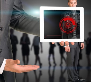 Businessman holding tablet with x-ray of man