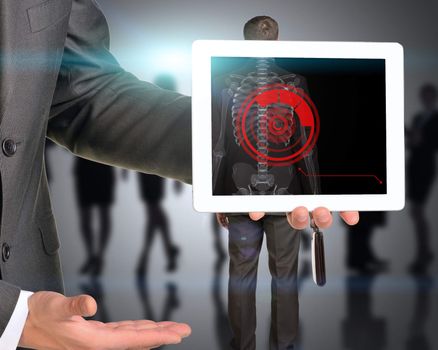 Businessman holding tablet with x-ray of man