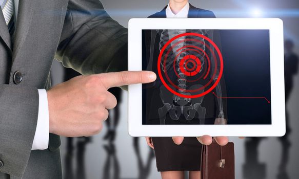 Businessman holding tablet with x-ray of woman