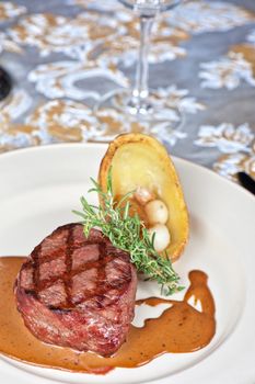 grilled beef steak with herbs and vegetables