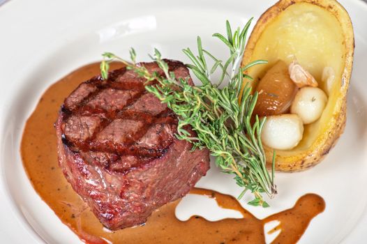grilled beef steak with herbs and vegetables