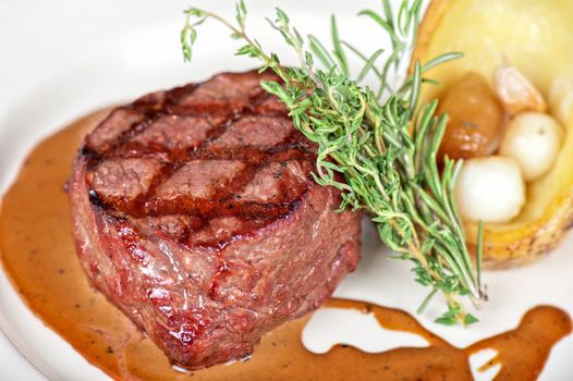 grilled beef steak with herbs and vegetables