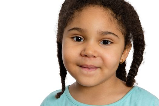 Close up Charming Four Year Old Girl with Braided Curly Hair Smiling at You Against White Background.