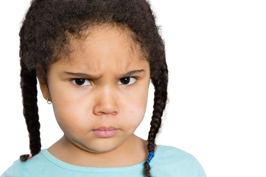 Close up Young Girl Staring at You with Angry Facial Expression Against White Background.