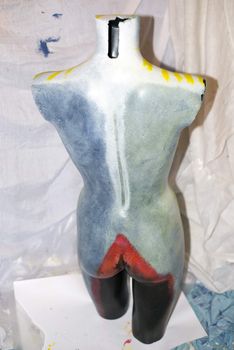 painted back of a mannequin full female torso in an artist studio