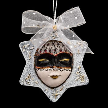 Beautiful mask of hand-worked for festive decoration, isolated on black background