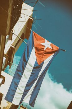 Cuban flag waiving from crumbling Havana building
