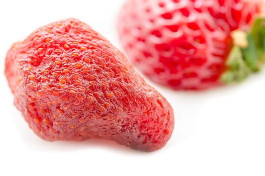 Close up dry strawberry with fresh strawberry on white background.
