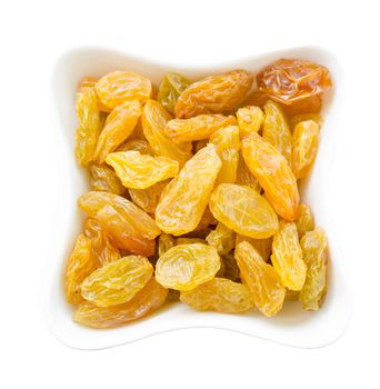 Yellow raisins in white bowl isolated on white background