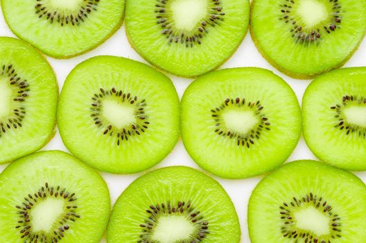 Fresh organic Kiwi fruit slices on white background.