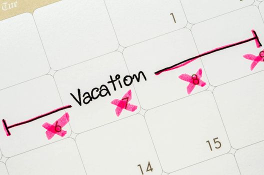 The word vacation is written on a calendar page