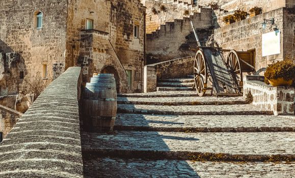 old historical scene with wood wagon and wine barrels typical tool used in the past, old style, in Matera, Italy UNESCO European Capital of Culture 2019