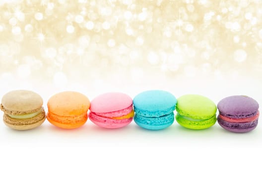 Colorful macaroons on white with beautiful abstract bokeh light.