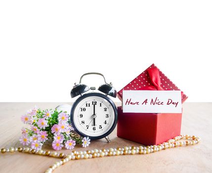 Have a nice day tag paper and alarm clock with red gift box, Copy space.