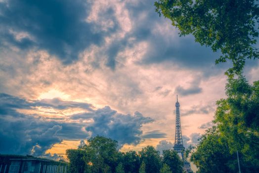 Stormy clouds forming over Eiffel Tower in Paris on summer evening