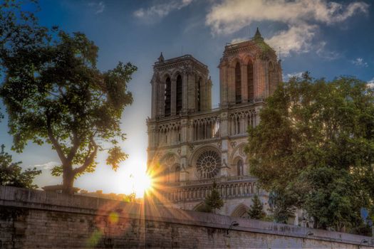Sunrise over Notre Dame cathedral in Paris on early summer morning