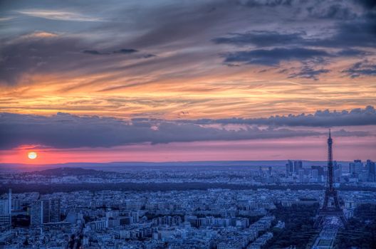 Scenic aerial view of sunset over Paris with dark Eiffel Tower