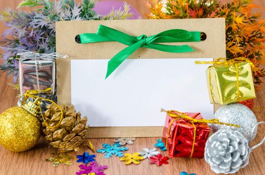 Blank tag paper with decorate christmas on wood background for your text.