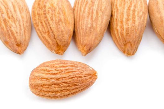 Many raw almond on white background.