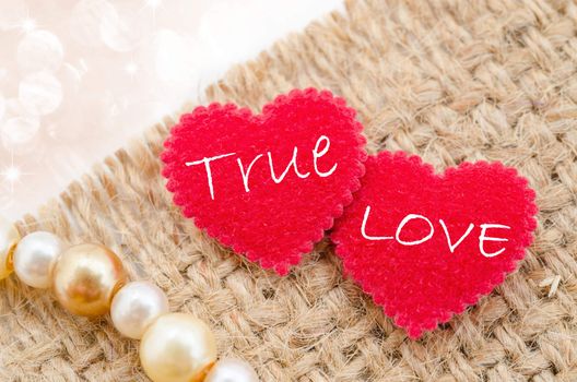 True love in red heart on sack background with beautiful bokeh.