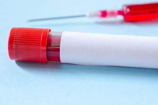 Syringe And Plastic Test Tube With Blood in laboratory.