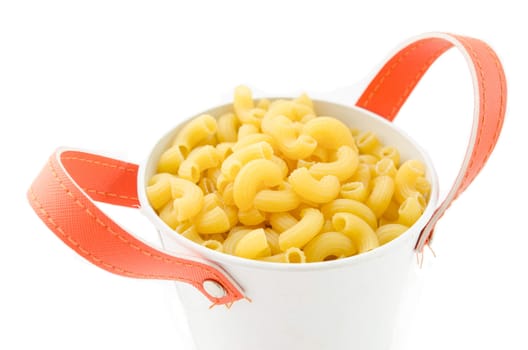Raw dry elbow macaroni. Italian Pasta raw food in white bowl on white background.