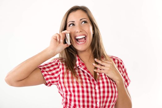 Portrait of beautiful cheerful girl using phone. White background.