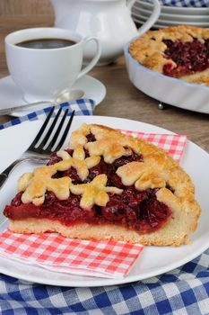 piece of cherry pie on a napkin and  cup of coffee