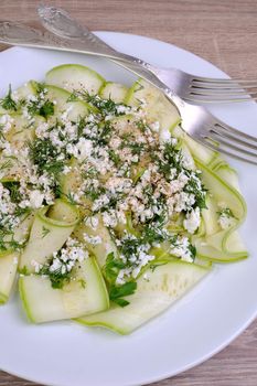 Salad with strips of zucchini, ricotta, dill and spices