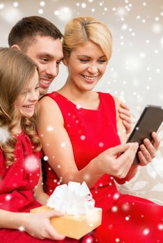 christmas, holidays, technology and people concept - smiling family with tablet pc taking selfie at home