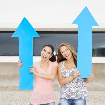 Teenage students holding blue arrows and pointing in diferent directions