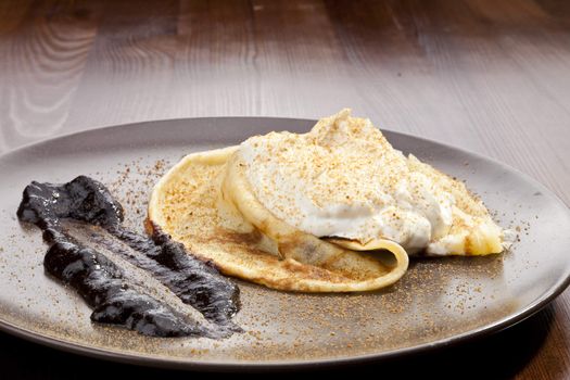 Crepe pancake with whipped cram and gingerbread powder